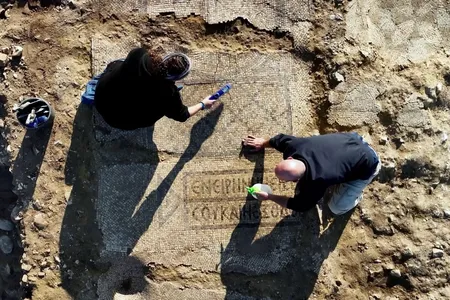 Maayan Margulis and Shira Lifshitz clean the mosaic.