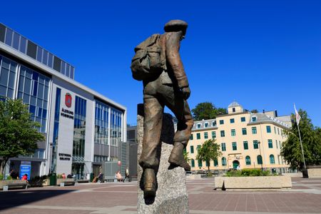 A statue in Joachim Ronneberg's honor stands tall outside the city hall in Alesund
