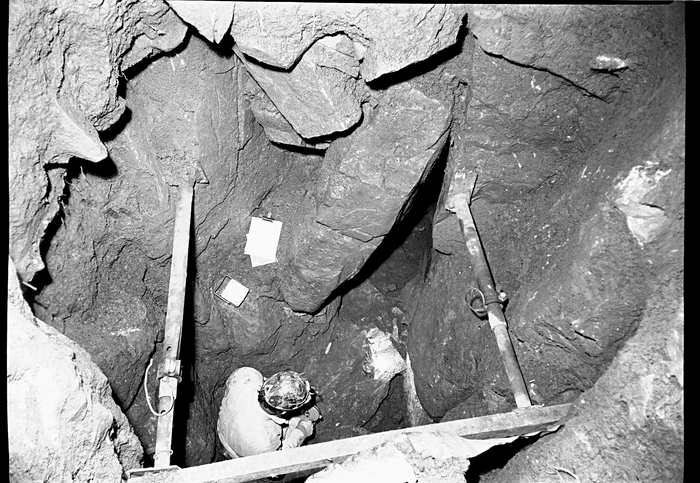 A person standing in a deep shaft