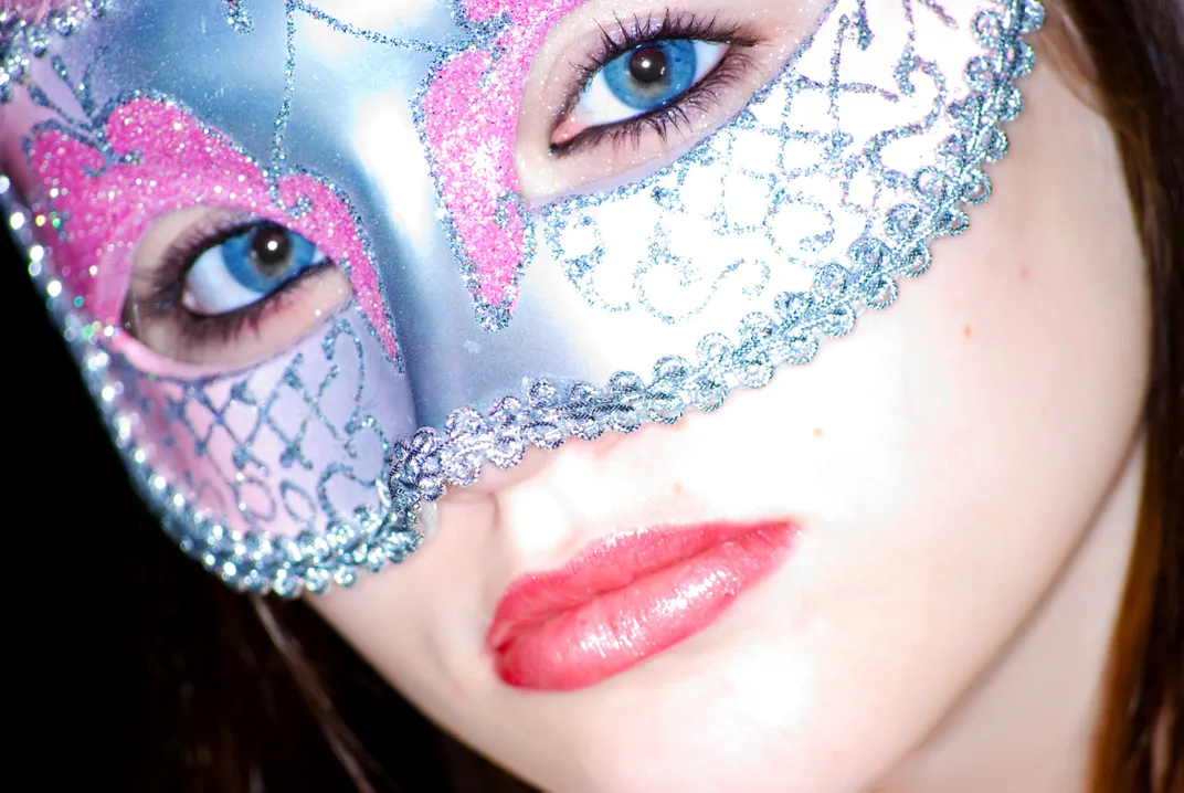 a close up of a women wearing a masking
