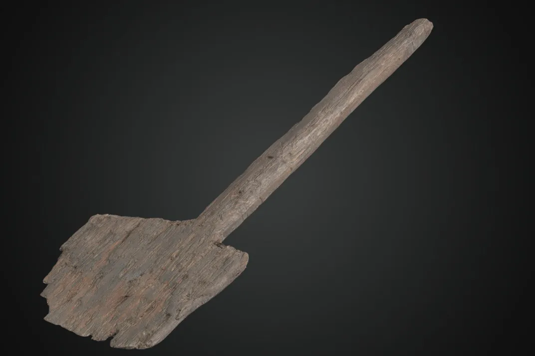 Wooden shovel against a black backdrop