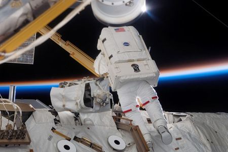 Spacewalking astronauts add solar arrays to the space station.