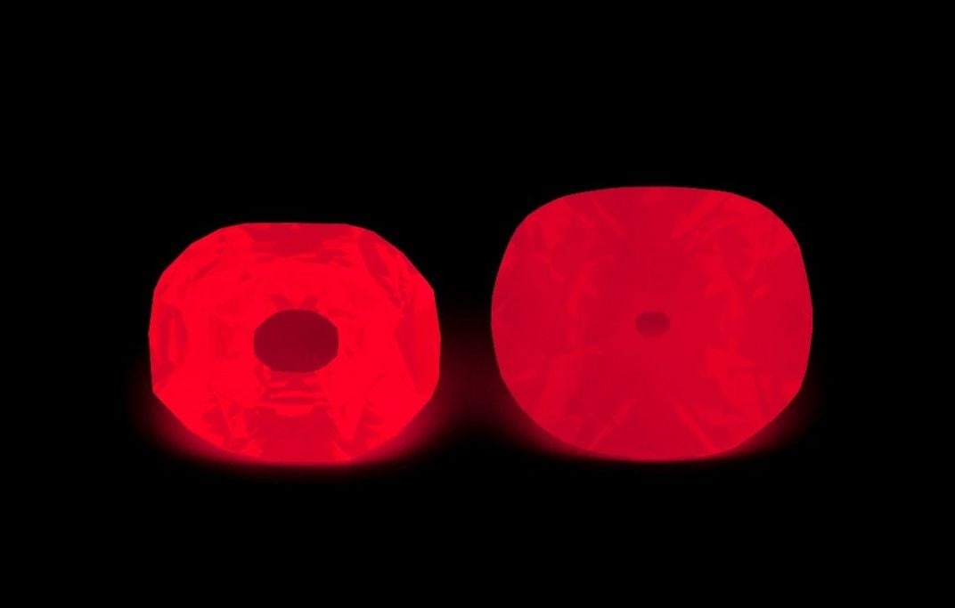 Two gems glowing red in the dark.