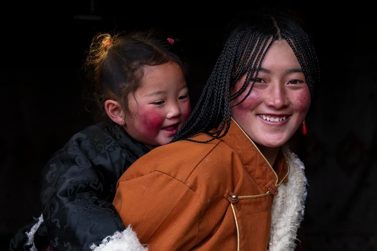 Rosy cheeks and warm garments are reasons to smile for this mother-daughter duo.