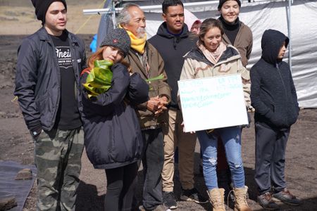 Our Stories students gather at Maunakea with kūpuna Calvin Hoe (center).