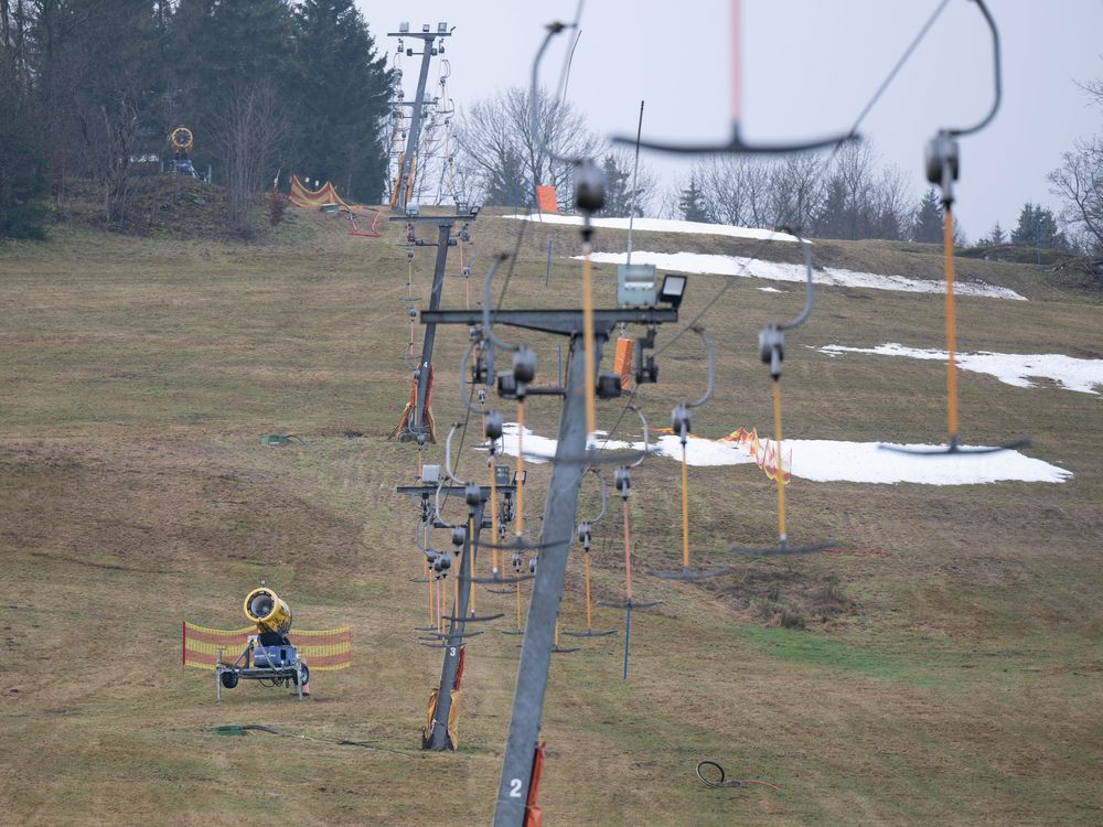 Green ski slopes with no snow