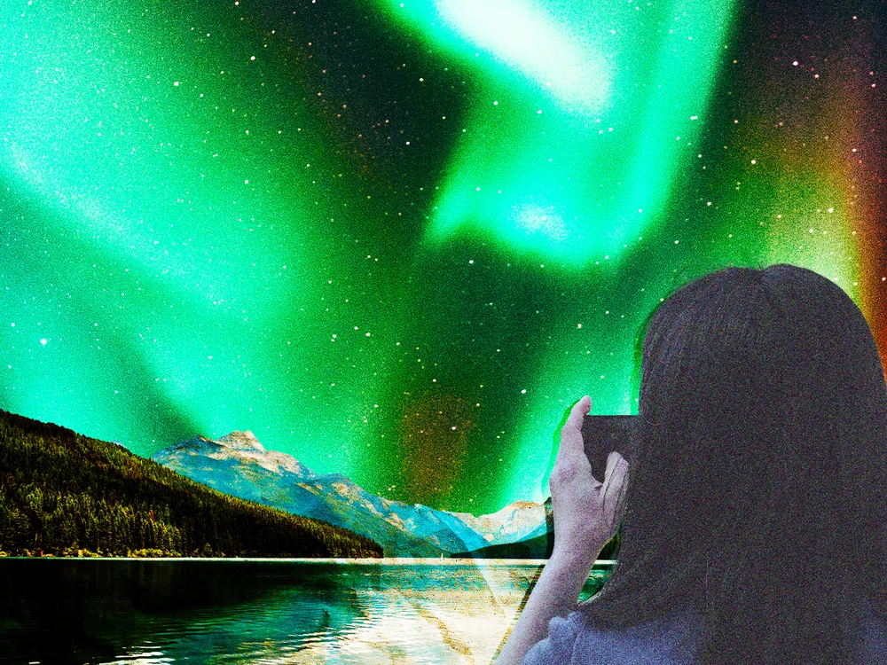 Person taking a photo of auroras