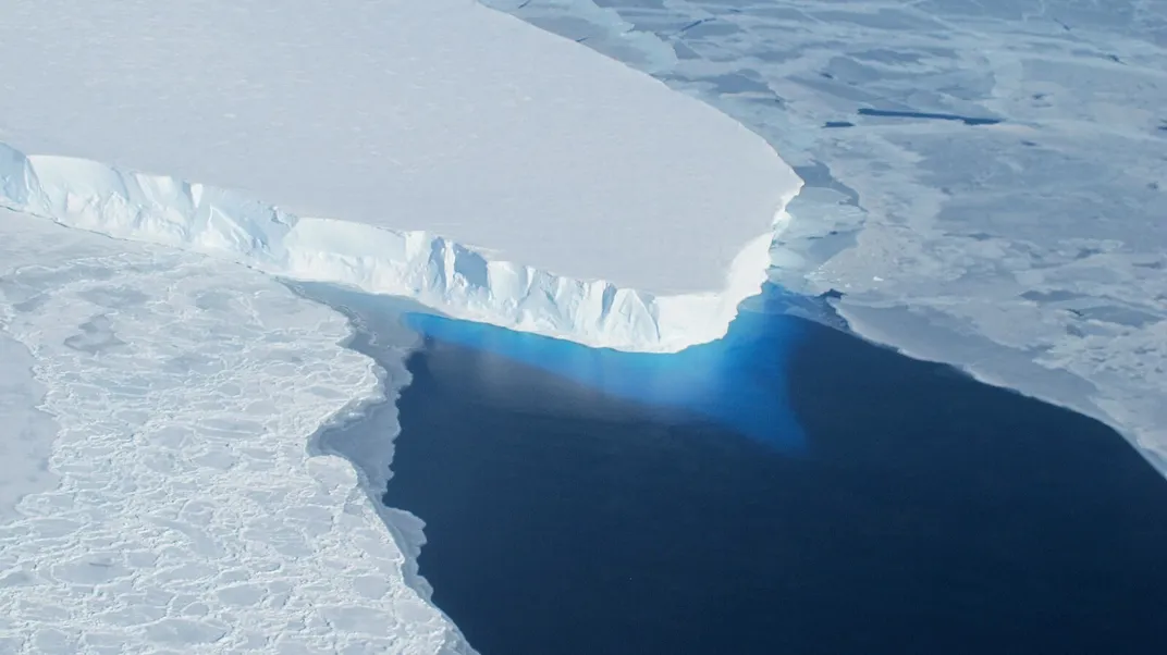 A glacier juts out into water