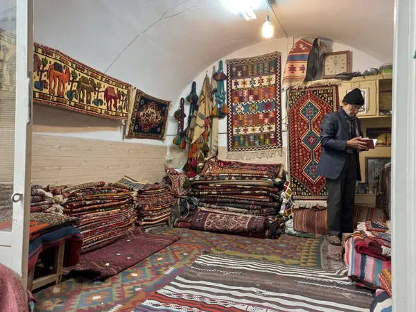 An old man's hand-woven carpet shop thumbnail