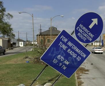 Sign marking an evacuation route, tilted by the storm. Photograph by Hugh Talman.