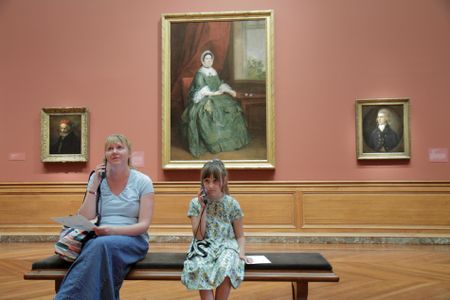 Mother and daughter listen to an audio tour at the Baltimore Museum of Art.