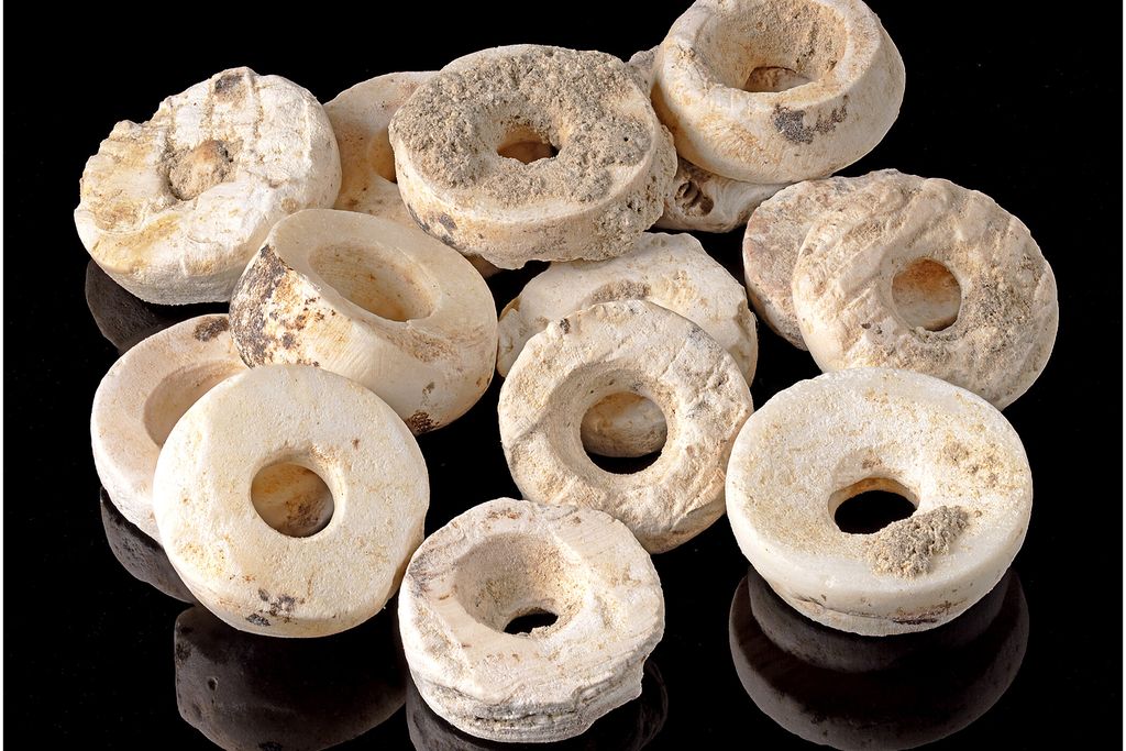 Disc-shaped white beads against a black background