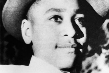 A young Emmett Till wearing a hat.