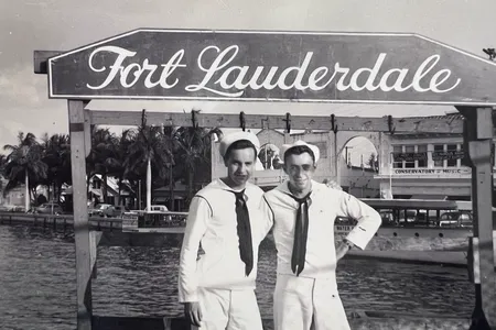 Walter Reed Parpart Jr. (right), the radioman on one of the missing planes, poses in front of a Fort Lauderdale sign in 1945.