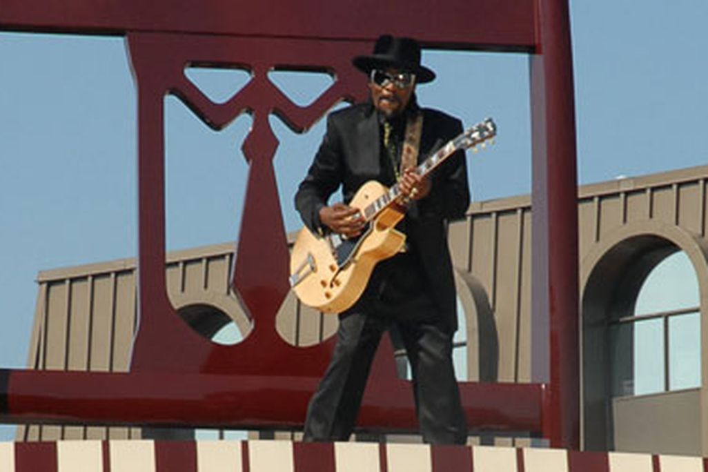 Go-go legend Chuck Brown poses on the Big Chair, a downtown Anacostia landmark.