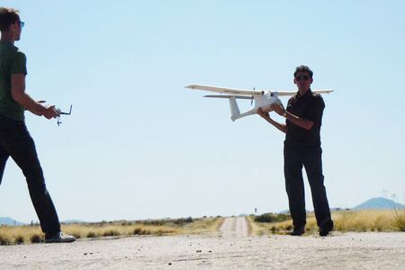 Learning to fly unmanned aircraft can now be part of a college education. A teacher at Arizona’s Embry-Riddle University readies a radio-control airplane for his student’s lesson.
