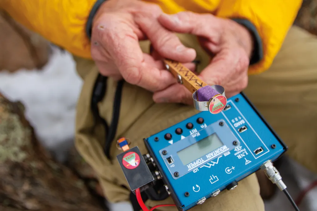 a close of hands holding radio equipment