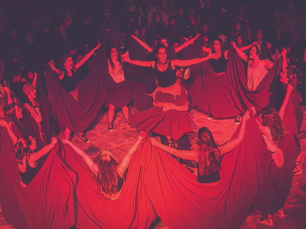 dancers join hands in a circle formation
