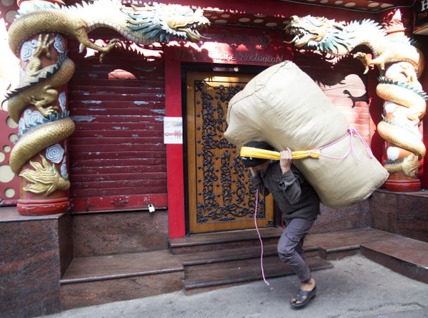 The man is carrying a huge sack. thumbnail