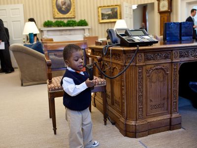 Corbin Fleming plays with President Obama's desk phone in 2012.  