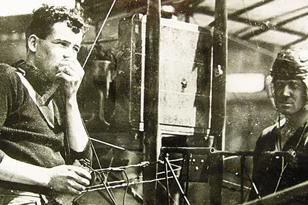 Just months after Lieutenant Paul Beck made an early airborne radio transmission, aviators test a receiving set - with the airplane's engine running - on North Island, Washington.