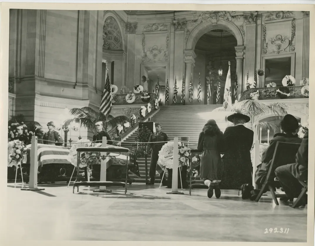 Family members of a fallen service member pray during a ceremony held in San Francisco