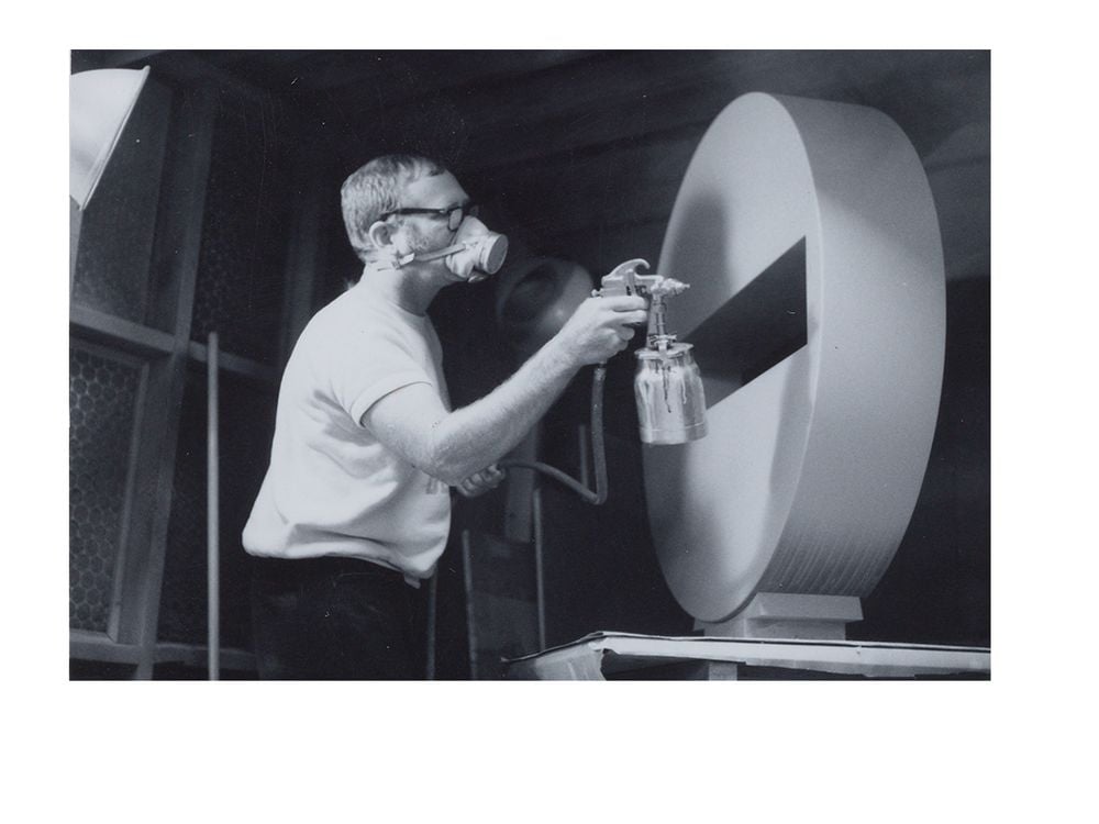 Photograph of Tony DeLap spray painting sculpture in Costa Mesa studio (detail), 1970 March / unidentified photographer. Tony DeLap papers, circa 1950-2015. Archives of American Art, Smithsonian Institution.