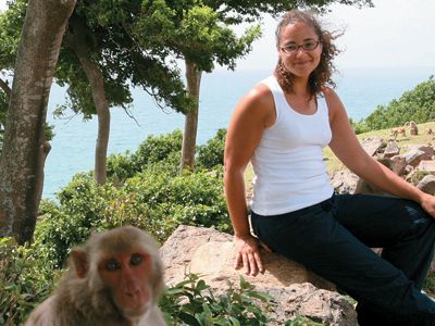 biologist Laurie Santos (with a research subject on Cayo Santiago)