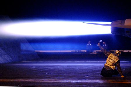 U.S. Navy Aviation Structural Mechanic 3rd Class Thomas Corbiere signals final safety checks are complete as an F/A-18E Super Hornet aircraft from Strike Fighter Squadron 147 launches from the flight deck of the Nimitz-class aircraft carrier USS John C. Stennis (CVN 74) Jan. 25, 2009, while under way in the Pacific Ocean on a six-month deployment. (DoD photo by Mass Communication Specialist 2nd Class Elliott Fabrizio, U.S. Navy/Released)