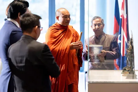 Phin Sokol, the abbot of Khemararangsi Buddhist Temple, performs a Buddhist blessing at a ceremony for the repatriation of three bronze statues that were previously part of the collection of the National Gallery of Australia.