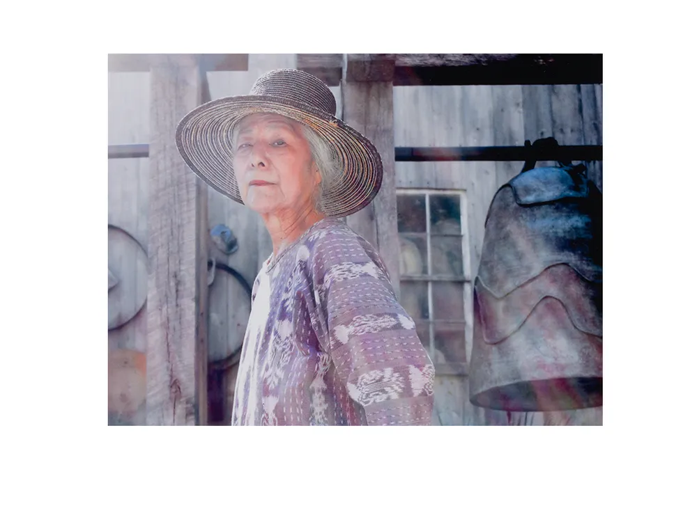 Photograph of Toshiko Takaezu posing with work (detail), September 2004. Toshiko Takaezu papers, 1937-2010. Archives of American Art, Smithsonian Institution.
