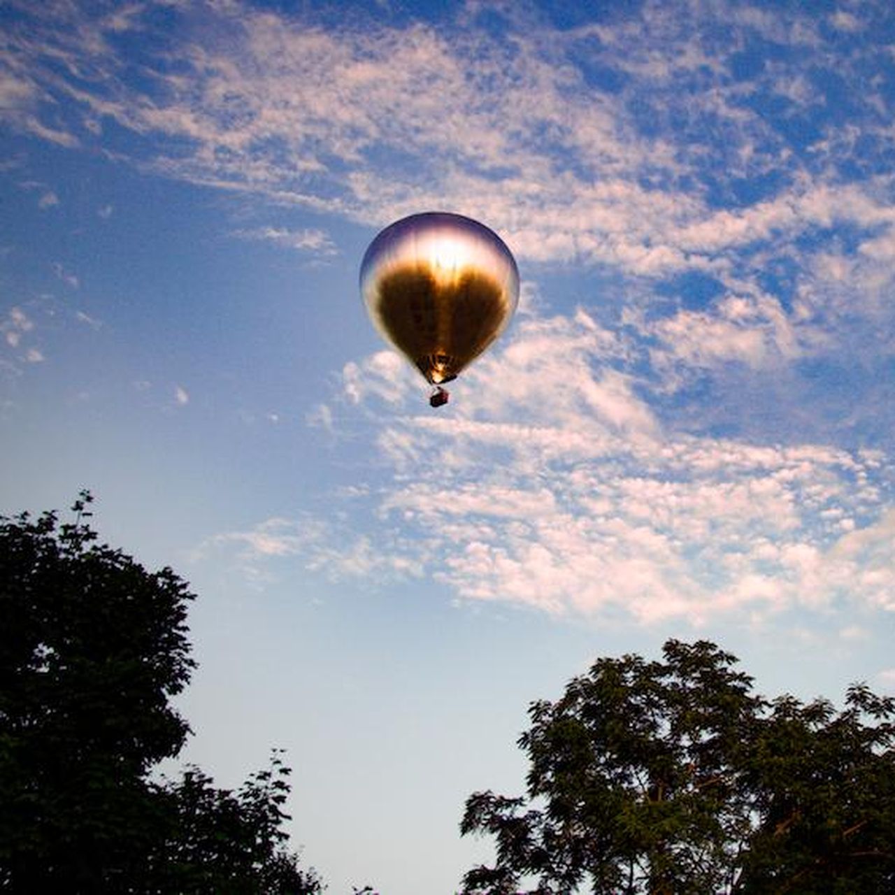 A Giant, Mirrored Hot Air Balloon Is Currently Traveling Over