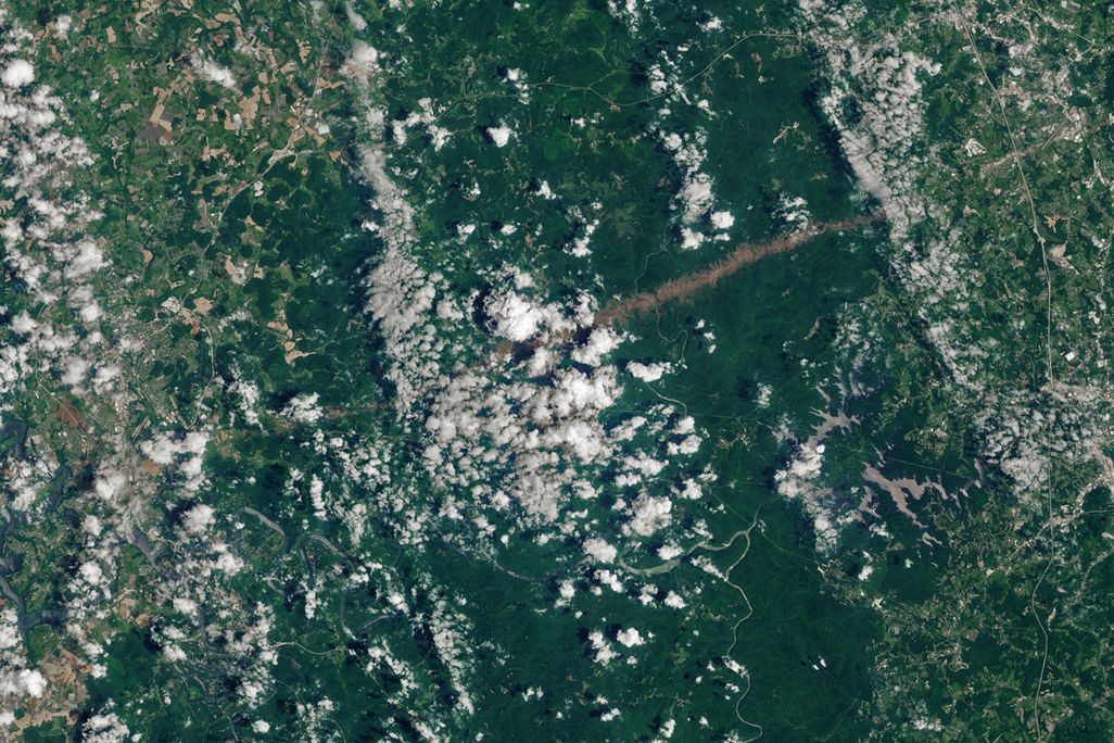 A satellite images features the tornado's trail of destruction running through Kentucky's Daniel Boone National Forest.