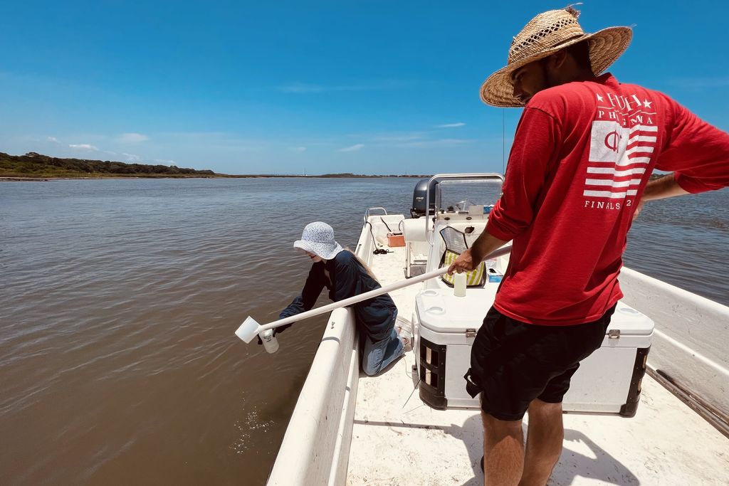 People collecting water samples from a boat