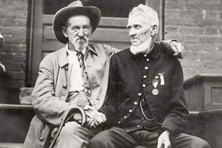 Comrades now, veterans in gray and blue shake hands at the 1913 Gettysburg reunion, much of the old animosity healed after a half century of peace.