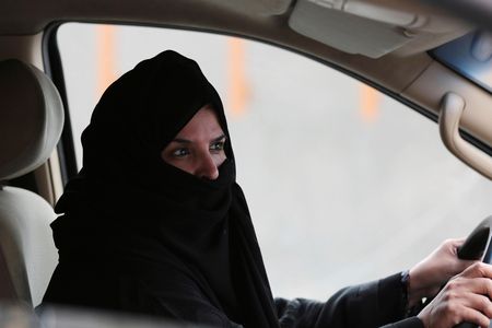 In this Saturday March 29, 2014 file photo, a woman drives a car on a highway in Riyadh, Saudi Arabia, as part of a campaign to defy Saudi Arabia's ban on women driving. Saudi Arabia authorities announced Tuesday Sept. 26, 2017, that women will be allowed to drive for the first time in the ultra-conservative kingdom from next summer, fulfilling a key demand of women's rights activists who faced detention for defying the ban.