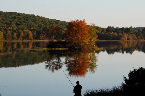 Silhouetted Fisherman on a Warm Autumn Day thumbnail