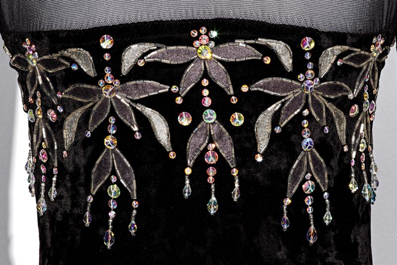 Rhinestones and Swarovski crystals accent the bodice of a black velvet ice skating costume