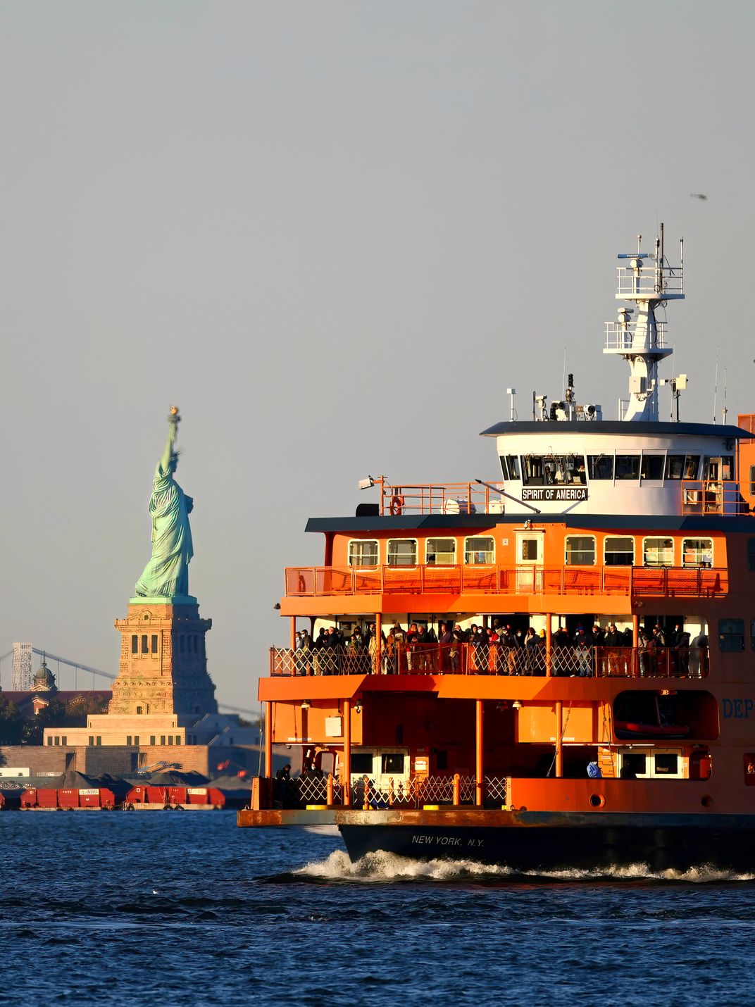 This Staten Island ferry floats nearby the Statue of Liberty in New York Harbor