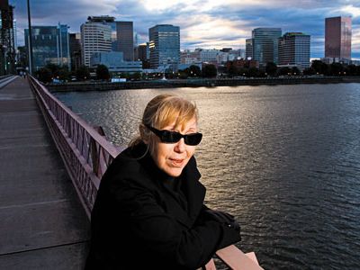 Portland has a "goofy, energetic optimism," says novelist Katherine Dunn, sitting on the city's Hawthorne Bridge.