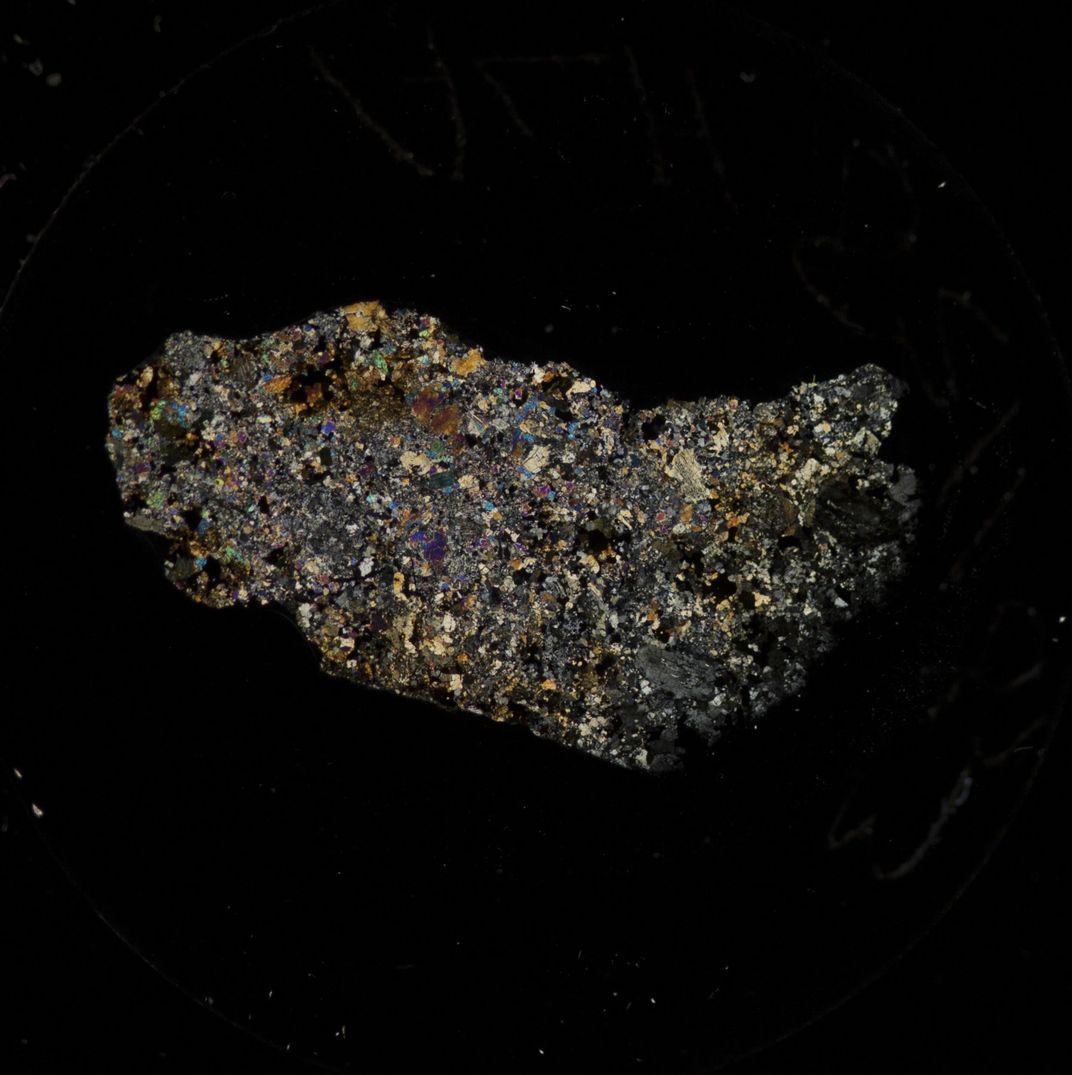 A colorful rock on a black background.