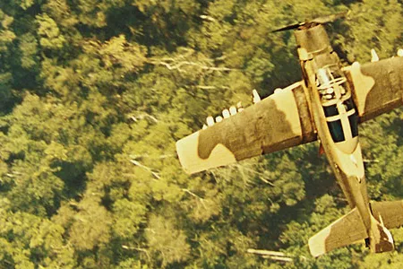 Over Vietnam in 1966, a Douglas A-1 flies cover on a rescue mission.