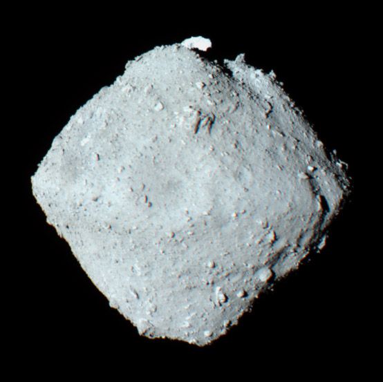 An image of the asteroid 162173 Ryugu as it appears in space. The asteroid looks like a grey diamond shaped chunk.