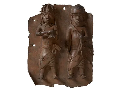 A plaque depicting a war chief and a royal military priest carrying a leather gift box