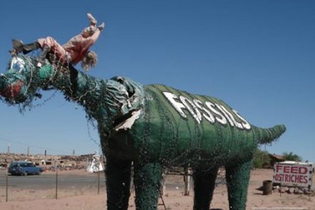 One of the sad dinosaurs at Stewart's Petrified Wood near Petrified Forest National Park in Arizona.