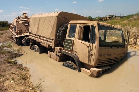 Soldiers use an M88A2 Hercules Recovery Vehicle to pull a truck from a deep puddle of mud during training. Soil moisture data from a NASA satellite could help prevent trucks getting stuck in the first place.