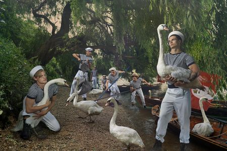 Royal swan uppers now wear scarlet jackets, but they still pilot traditional rowing skiffs. The 2018 swan upping will begin July 16.
