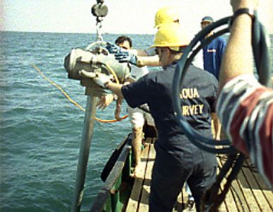 Researchers collect core samples in 2001. During drilling operations, several anchors placed by divers secured the boat to the sea floor.