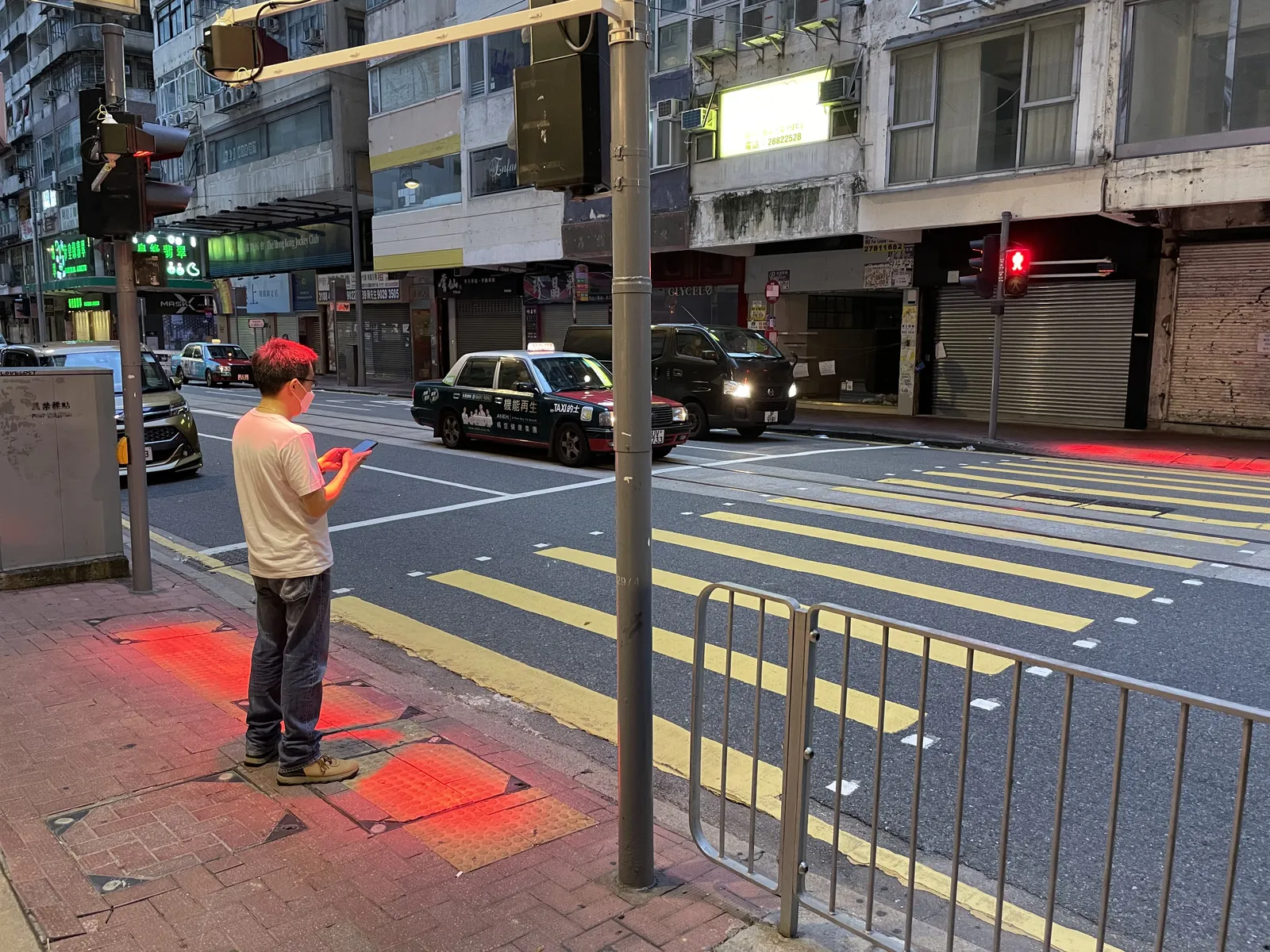 Crosswalk accident. Pedestrian with smartphone and headphones