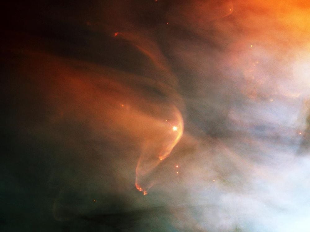 orange dust surrounds a bright star